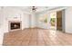 Living room featuring a fireplace, tile floors, ceiling fan, and sliding glass doors at 977 Courtney Valley St, Henderson, NV 89052