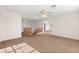 Spacious carpeted living room with a ceiling fan and natural light coming through the windows at 977 Courtney Valley St, Henderson, NV 89052