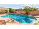 Inviting pool with attached spa, framed by rock accents and lush greenery, perfect for outdoor relaxation and entertainment at 977 Courtney Valley St, Henderson, NV 89052