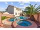 Inviting backyard pool and spa with lush landscaping and privacy fencing at 977 Courtney Valley St, Henderson, NV 89052