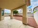Covered back patio with view of the gravel landscaping and block wall fence at 9821 Sedona Shrine Ave, Las Vegas, NV 89148