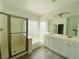 Bright bathroom with a shower, double sinks, and a garden tub at 9821 Sedona Shrine Ave, Las Vegas, NV 89148