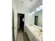 Modern bathroom vanity with dual sinks, stylish lighting, and updated flooring at 9821 Sedona Shrine Ave, Las Vegas, NV 89148
