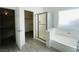 Bright bathroom featuring a shower, tub and walk in closet at 9821 Sedona Shrine Ave, Las Vegas, NV 89148