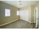 Neutral bedroom featuring wood-look flooring and closet with sliding doors at 9821 Sedona Shrine Ave, Las Vegas, NV 89148