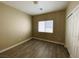 Bedroom featuring a window and wood-look floors at 9821 Sedona Shrine Ave, Las Vegas, NV 89148