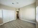 Neutral bedroom featuring wood-look flooring and closet with sliding doors at 9821 Sedona Shrine Ave, Las Vegas, NV 89148