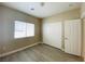 Neutral bedroom featuring wood-look flooring, a window, and a closet with sliding doors at 9821 Sedona Shrine Ave, Las Vegas, NV 89148