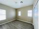 Neutral bedroom with wood-look flooring and two windows for natural light at 9821 Sedona Shrine Ave, Las Vegas, NV 89148