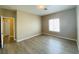 Spacious bedroom featuring wood-look flooring, a neutral color scheme, and natural light at 9821 Sedona Shrine Ave, Las Vegas, NV 89148