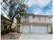 Two-story home with a two-car garage, landscaped front yard, and neutral-colored facade at 9821 Sedona Shrine Ave, Las Vegas, NV 89148