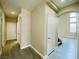 Bright hallway showcasing the flooring, neutral walls, and access to various rooms in the home at 9821 Sedona Shrine Ave, Las Vegas, NV 89148