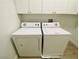 Close-up of modern, white washing machine and dryer in well-lit laundry room at 9821 Sedona Shrine Ave, Las Vegas, NV 89148