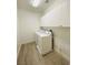 Bright laundry room with modern washer and dryer and overhead white cabinets at 9821 Sedona Shrine Ave, Las Vegas, NV 89148