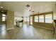 Spacious living room features a ceiling fan and hardwood style floors leading into an open kitchen at 9821 Sedona Shrine Ave, Las Vegas, NV 89148