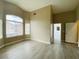 Bright living room featuring wood-look flooring and natural light with access to the bathroom at 9821 Sedona Shrine Ave, Las Vegas, NV 89148