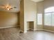 Open living room features a fireplace and bright windows providing lots of natural light at 9821 Sedona Shrine Ave, Las Vegas, NV 89148