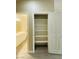 Pantry with shelves near a bathroom with double sink vanity, offers lots of storage space at 9821 Sedona Shrine Ave, Las Vegas, NV 89148