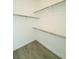 Walk-in closet with shelving and wood-look flooring at 9821 Sedona Shrine Ave, Las Vegas, NV 89148