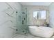 This modern bathroom features a sleek glass shower, soaking tub, and marble accents at 9937 Whalers Landing Ct, Las Vegas, NV 89117