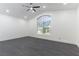 Large bedroom with ceiling fan, recessed lighting, and a large arched window overlooking the neighborhood at 9937 Whalers Landing Ct, Las Vegas, NV 89117
