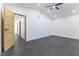 Bright bedroom featuring gray wood flooring, recessed lights, ceiling fan, and vaulted ceilings at 9937 Whalers Landing Ct, Las Vegas, NV 89117
