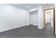 Spacious bedroom showcasing modern gray floors, fresh paint, and an open nook for storage at 9937 Whalers Landing Ct, Las Vegas, NV 89117