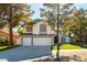 Charming two-story home with a well-manicured lawn, mature trees, and a three-car garage at 9937 Whalers Landing Ct, Las Vegas, NV 89117