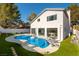 Back exterior of the home showcasing a pool and well-manicured backyard with a large patio area at 9937 Whalers Landing Ct, Las Vegas, NV 89117