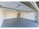 Spacious garage featuring a sealed floor, clean white walls, and a sturdy overhead support structure at 9937 Whalers Landing Ct, Las Vegas, NV 89117