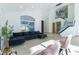 Spacious living room featuring modern staircase and large windows offering backyard view at 9937 Whalers Landing Ct, Las Vegas, NV 89117