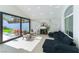 Bright living room featuring a marble accent wall, fireplace, modern furniture, and access to the backyard at 9937 Whalers Landing Ct, Las Vegas, NV 89117