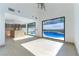 Bright living room featuring large windows with a clear view of the pool at 9937 Whalers Landing Ct, Las Vegas, NV 89117
