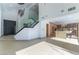Spacious living room with modern staircase and open kitchen at 9937 Whalers Landing Ct, Las Vegas, NV 89117