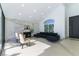 Bright living room featuring a marble accent wall, fireplace, modern furniture, and access to the entrance at 9937 Whalers Landing Ct, Las Vegas, NV 89117