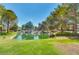 Community pond surrounded by well-maintained green spaces, providing a tranquil and natural amenity at 9937 Whalers Landing Ct, Las Vegas, NV 89117