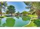 Relaxing pond scene surrounded by mature trees and rock features, creating a peaceful community park at 9937 Whalers Landing Ct, Las Vegas, NV 89117