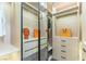 This walk-in closet features custom shelving and modern lighting at 9937 Whalers Landing Ct, Las Vegas, NV 89117