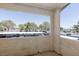 Balcony view showing nearby buildings, mature trees, and parking spots under carports at , Las Vegas, NV 89120