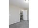 A carpeted bedroom featuring a walk-in closet with installed shelving for optimal storage solutions at , Las Vegas, NV 89120