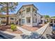 Condominium exterior featuring neutral stucco, walkway, and covered parking in a sunny community at , Las Vegas, NV 89120