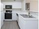 Kitchen with white cabinets, stainless sink, and black appliances at , Las Vegas, NV 89120