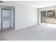 Bright living room with washer/dryer closet and sliding glass doors to patio at , Las Vegas, NV 89120