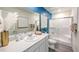 Bright bathroom featuring a white vanity, shower, and blue accent wall at , North Las Vegas, NV 89084