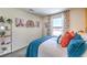 Cozy bedroom with a rattan headboard, colorful pillows, and plenty of natural light at , North Las Vegas, NV 89084