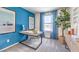 Bright office space with blue accent wall, large window and a modern desk setup at , North Las Vegas, NV 89084
