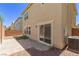 View of the backyard with a brick patio, rock landscaping, and an exterior air conditioning unit at 104 Big Cliff Ave, North Las Vegas, NV 89031