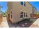 View of backyard featuring a brick patio, rock landscaping and the building's exterior at 104 Big Cliff Ave, North Las Vegas, NV 89031