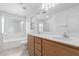 Bathroom featuring double sinks, and separate shower and tub at 104 Big Cliff Ave, North Las Vegas, NV 89031