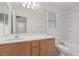 Bright bathroom featuring a single sink vanity with a large mirror and a shower-tub combination at 104 Big Cliff Ave, North Las Vegas, NV 89031